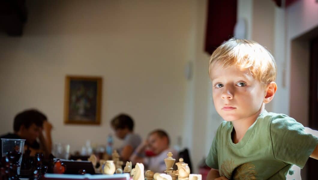 a boy in a green shirt in a chess club