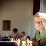 a boy in a green shirt in a chess club