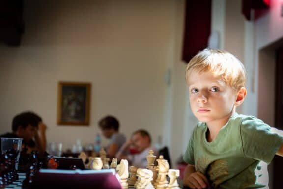 a boy in a green shirt in a chess club