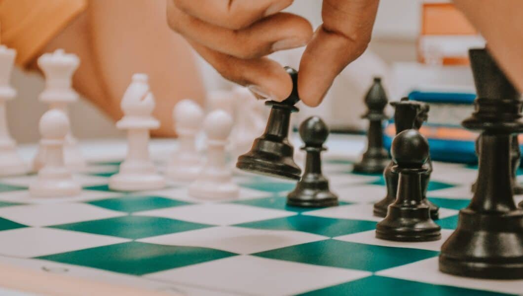 a chess player moving a black pawn