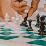 a chess player moving a black pawn