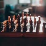 wooden chess board with pieces in the starting position