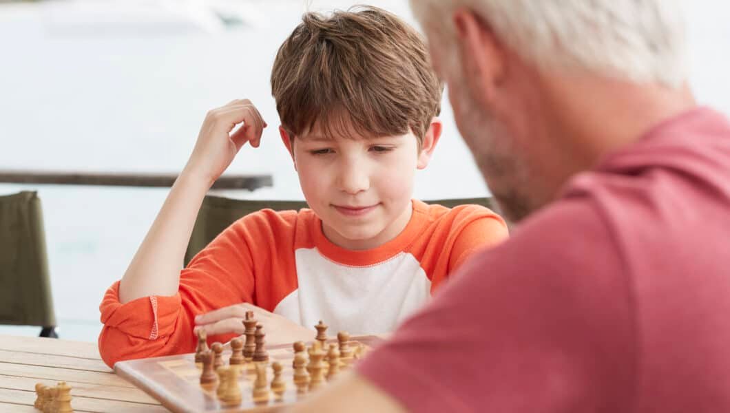 grandson and grandfather playing chess