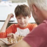 grandson and grandfather playing chess