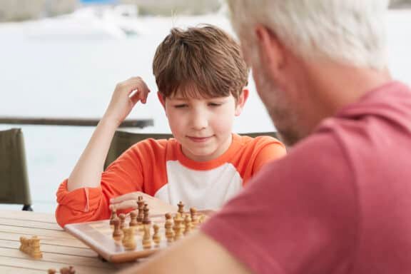 grandson and grandfather playing chess