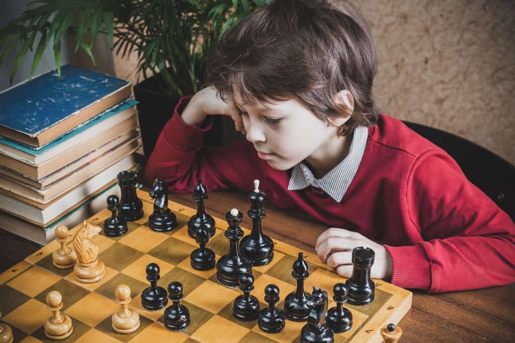 Thoughtful six years old chess player